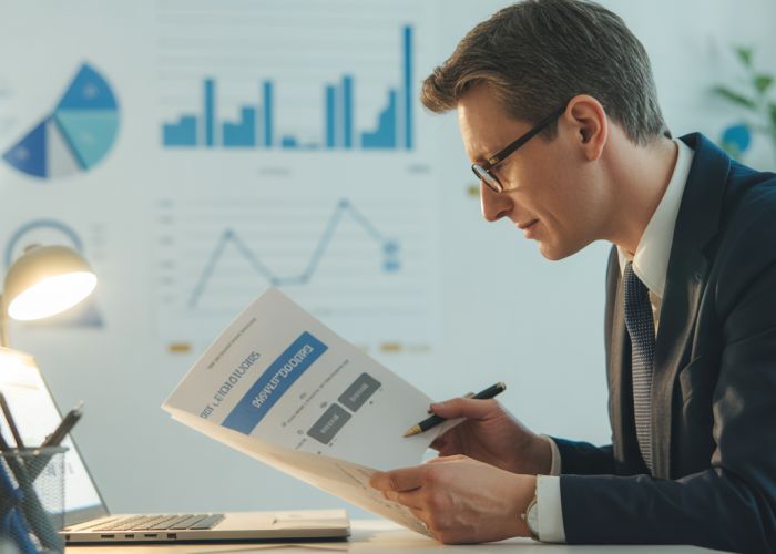 Financial advisor reviewing life insurance policy valuation documents.